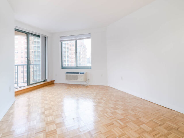 Bedroom with Balcony and Parquet Flooring