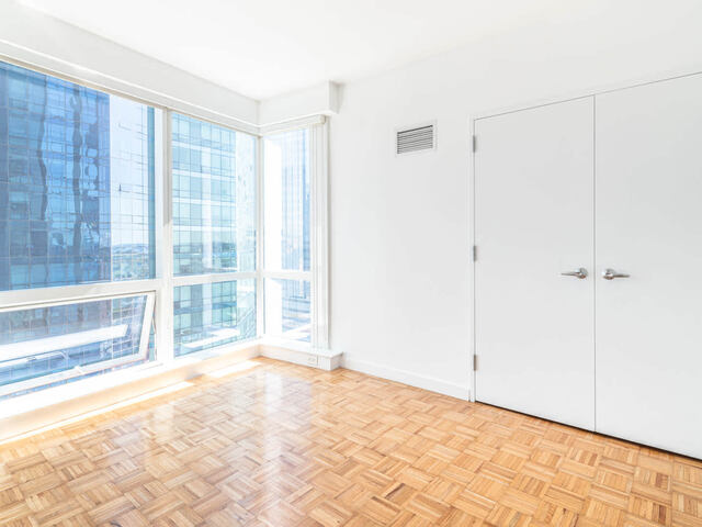 Bedroom with Floor-to-ceiling Windows and Hard Surface Flooring