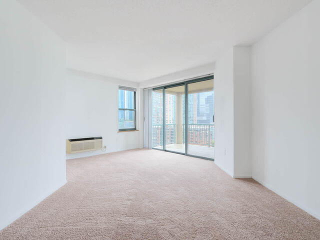 Carpeted Bedroom with Balcony