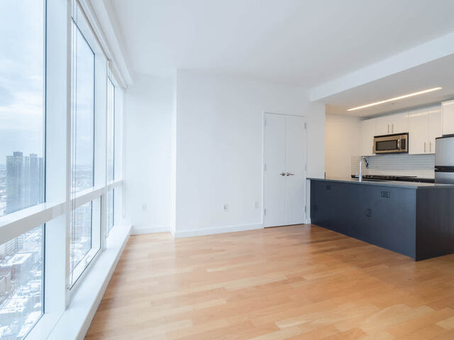 Living Room with Hard Surface Flooring and Floor to Ceiling Windows